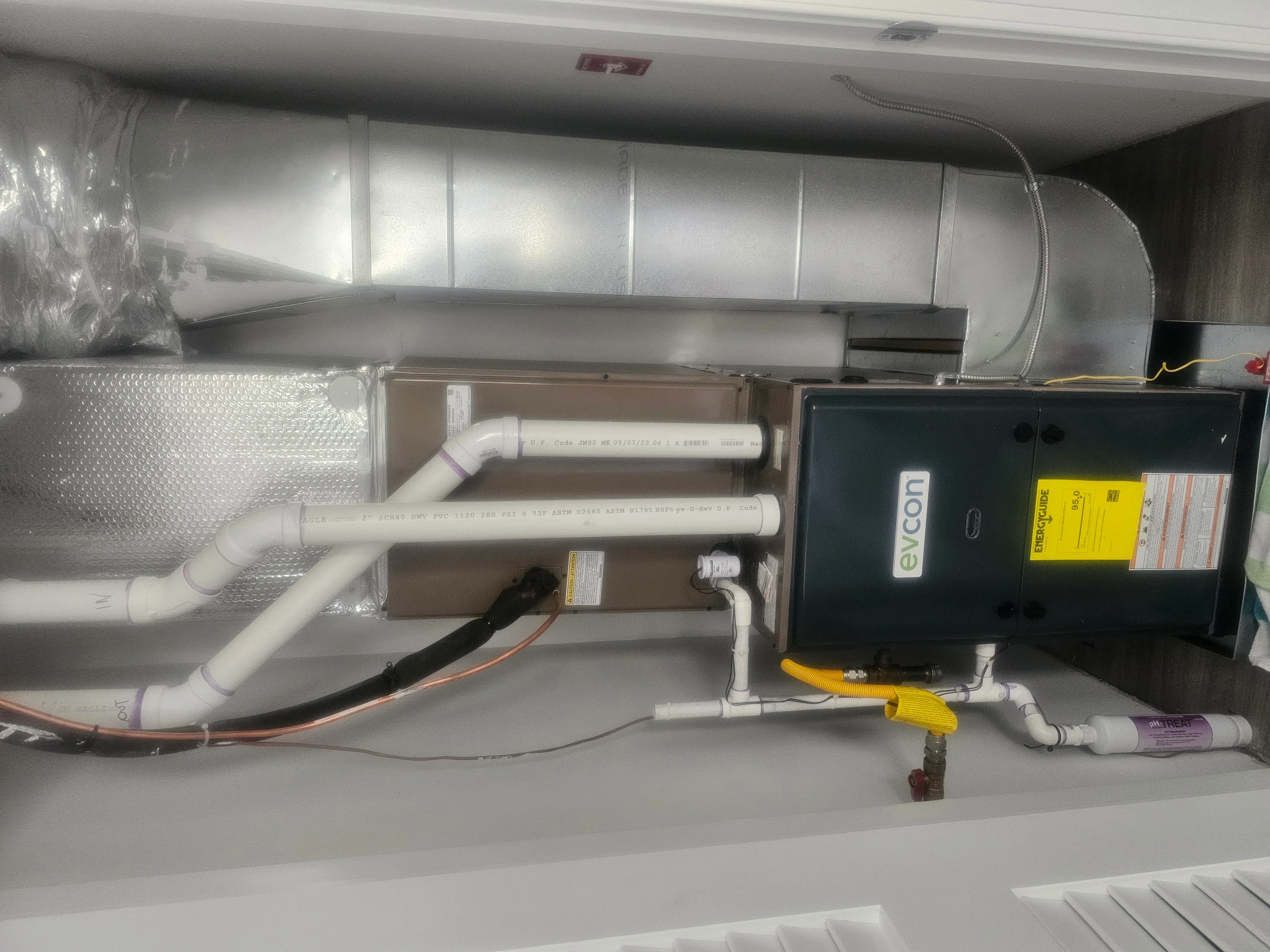 Under-sink RO water filtration system with dual filters, control unit, and storage tank installed