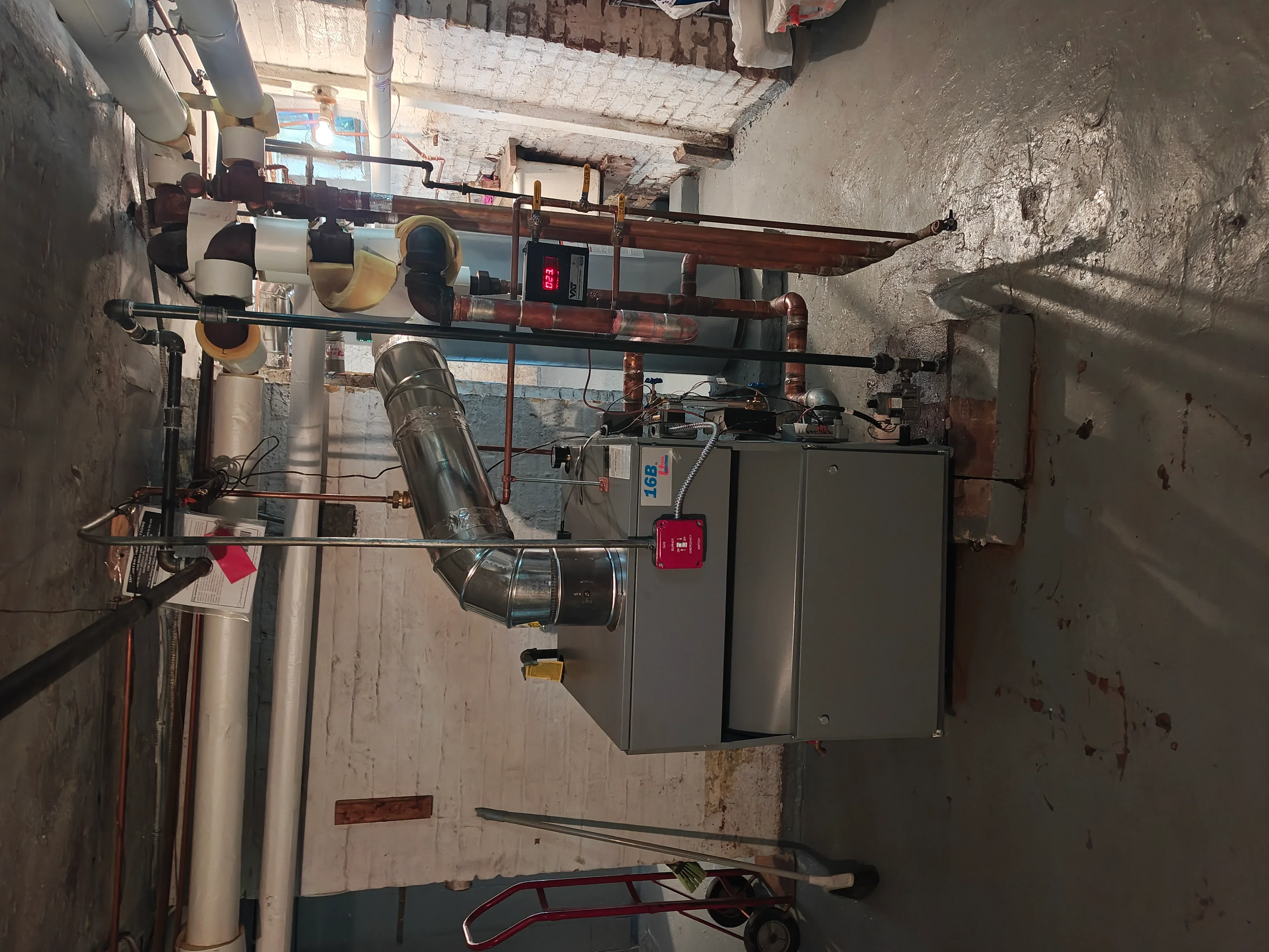 Commercial HVAC boiler system with copper piping, ductwork, and control panel installation