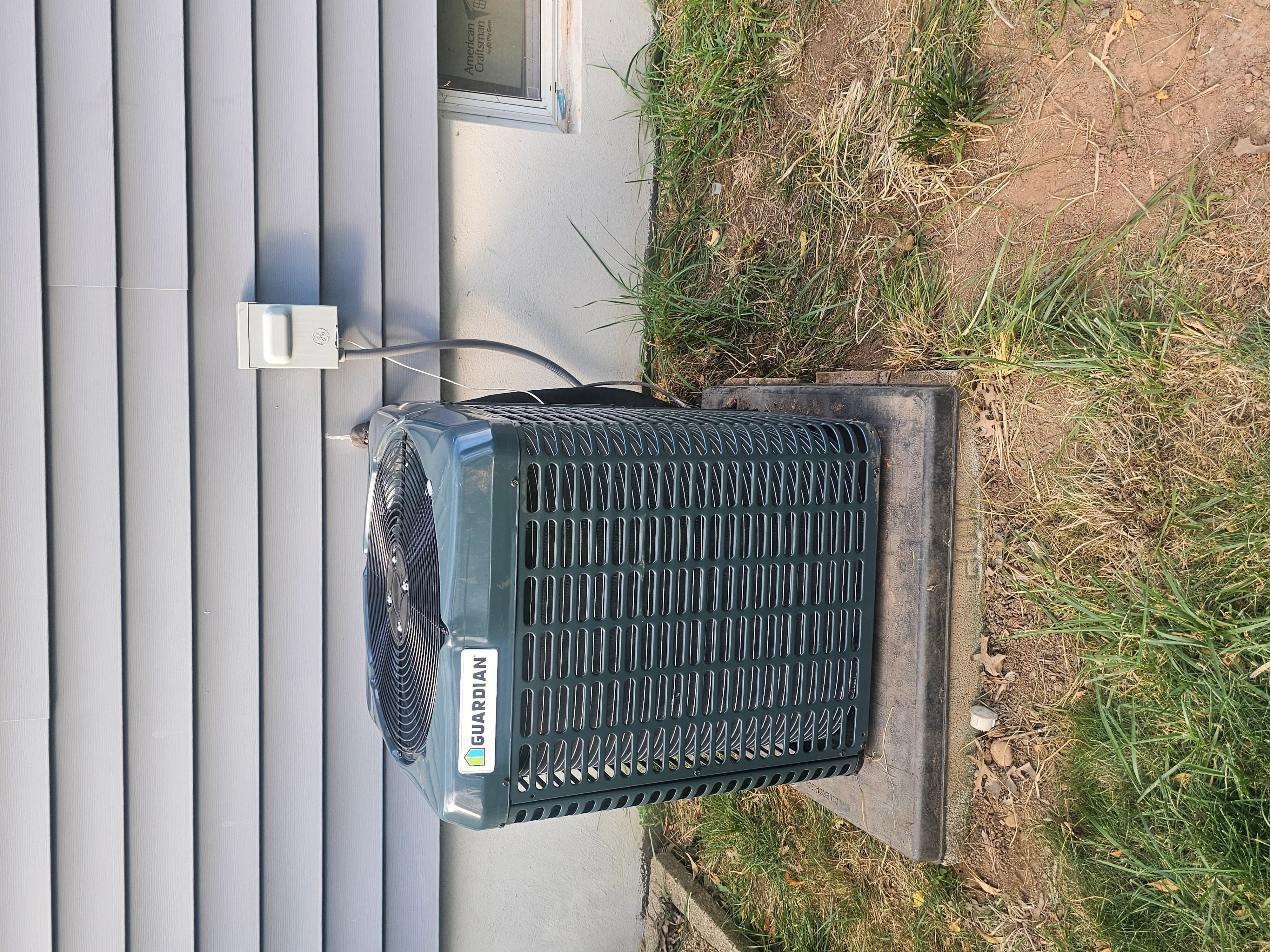 Guardian AC condenser unit installed on concrete pad with power line connection