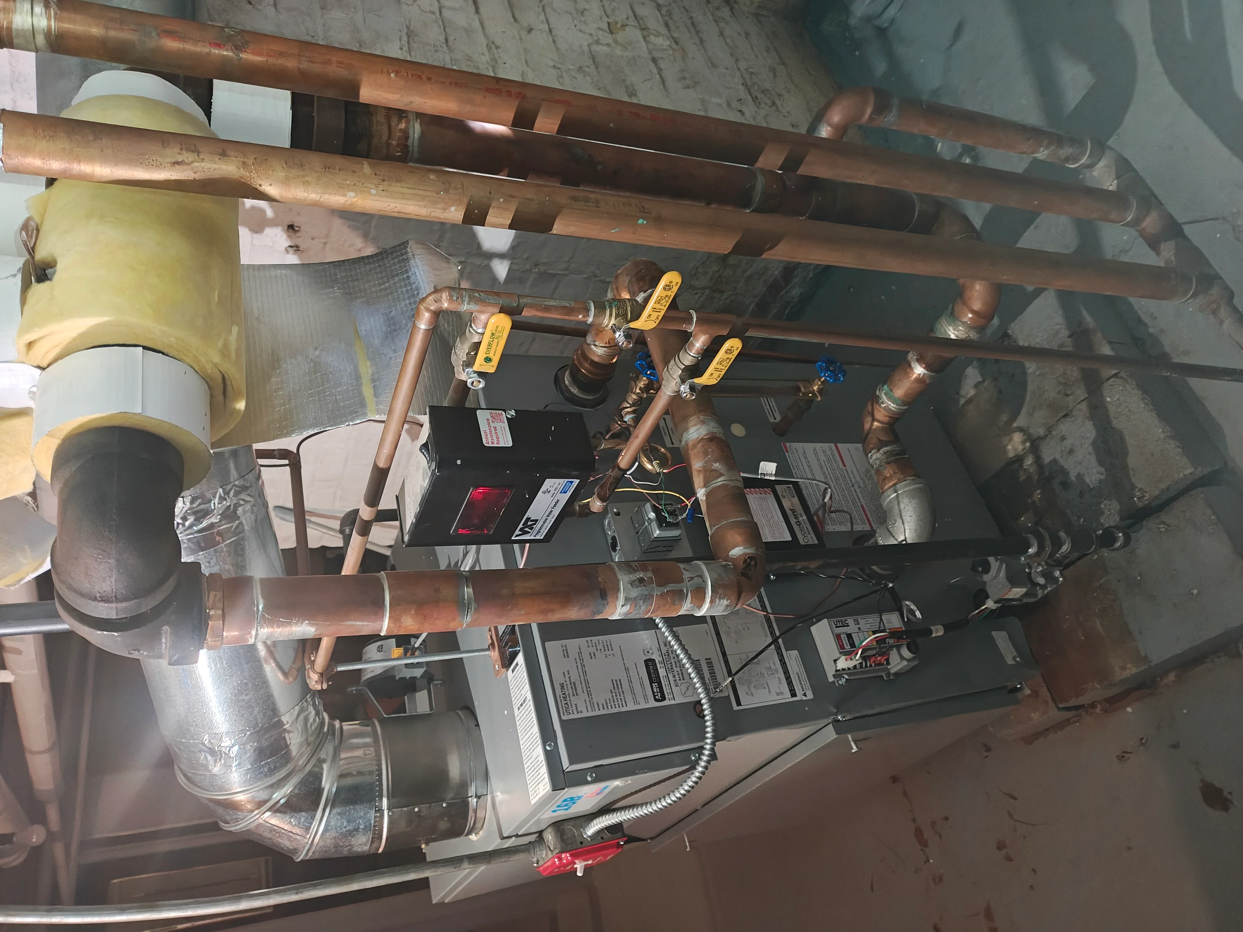 Commercial HVAC system with copper piping, zone valves, and control boards installed